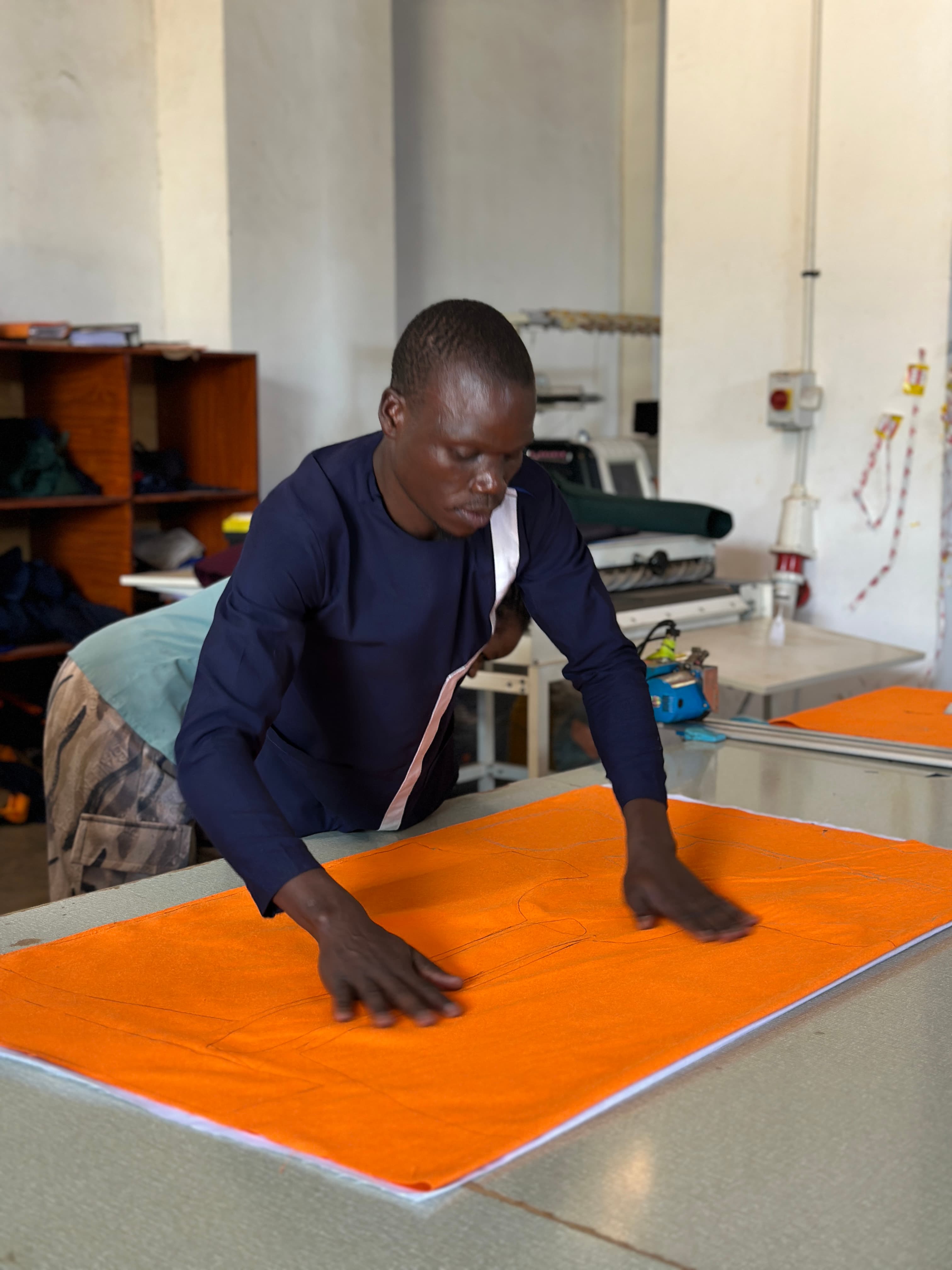 Dorta team member preparing fabric for garment production